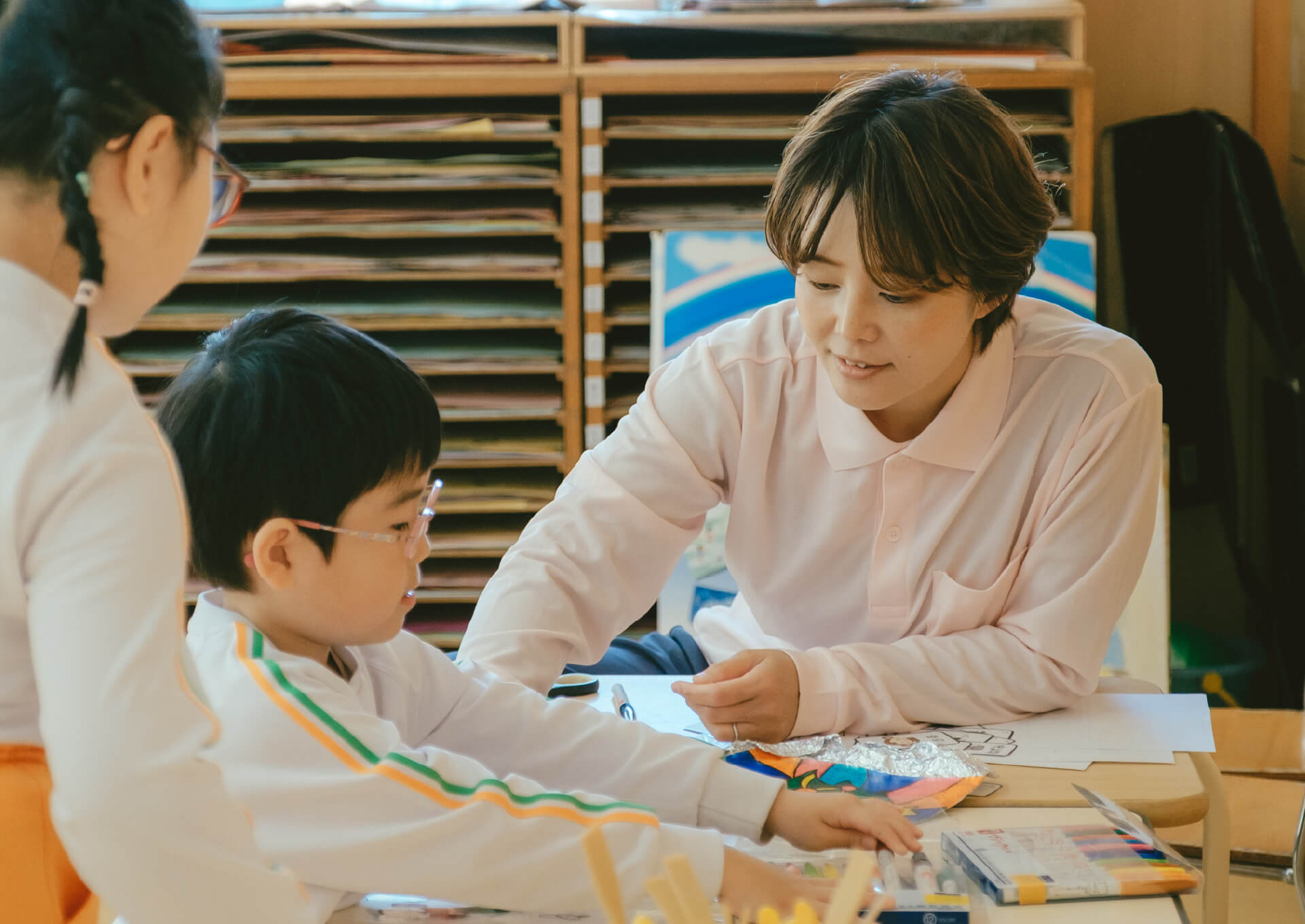 先生と一緒にお絵かきを楽しむ園児